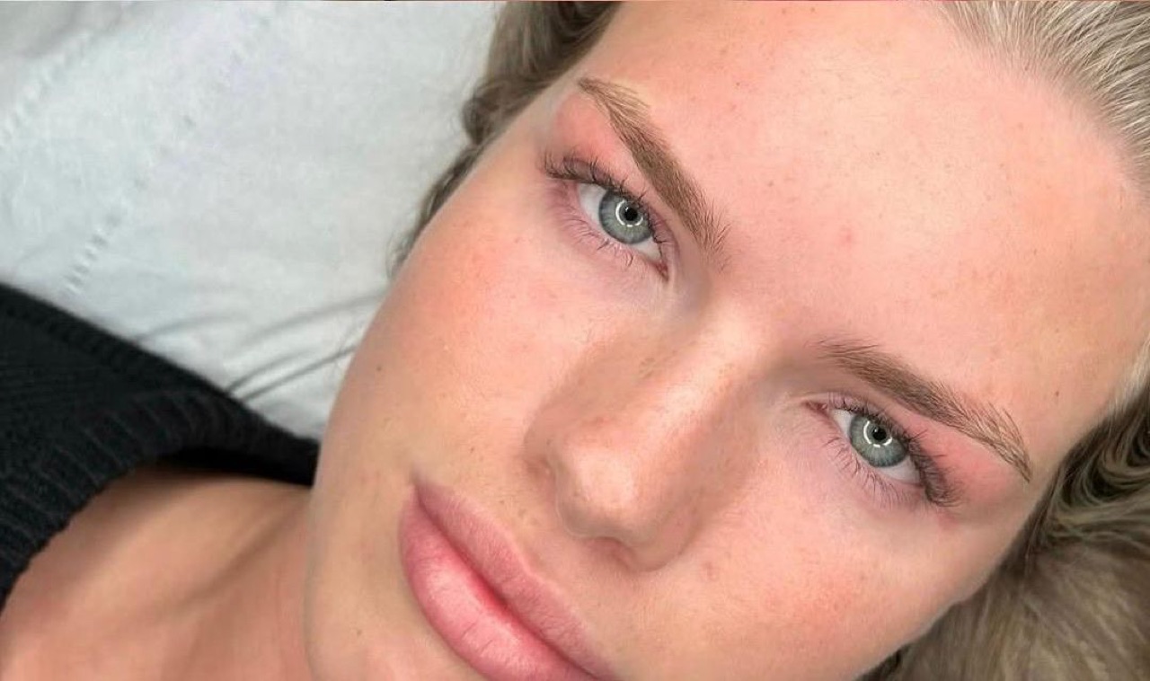 A natural microblading result — soft, defined brows on a glowing complexion.